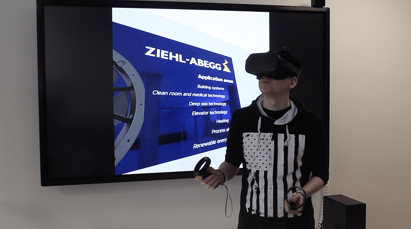 Man with HTC Vive Virtual Reality VR goggles testing out application for ZIEHL-ABEGG with controllers